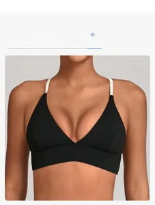 Detail of color-block sports bra with thin white straps and a wide supporting underband