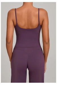 Detail of cross-back straps and V-waist seam on dark purple high-stretch yoga set