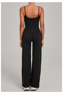 Back view of a black high-waisted wide-leg yoga set with thin straps and elastic fabric