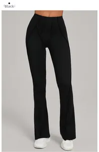 Detail of high waisted black flare yoga pants with Y-shaped decorative seams and slit hem