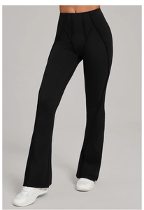 Detail showing decorative stitching and high waist of black flared yoga pants on model