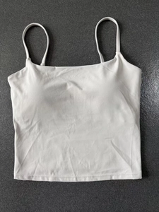 Flat lay detail of white square-neck sports tank top with thin straps and padded cups