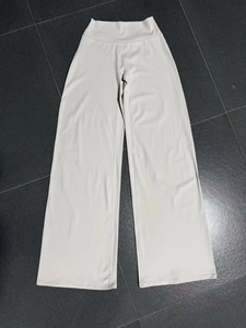 Flachbild-Detailansicht der cremefarbenen Yoga-Hose mit hohem Bund und weitem Beinverlauf