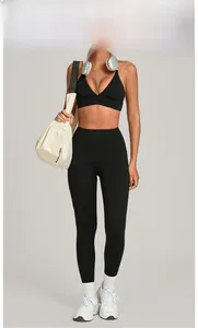 Two-piece black yoga set with V-neck sports bra and high-waisted leggings on model