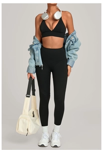 Detail of black high-waist yoga set with deep V-neck sports bra and leggings