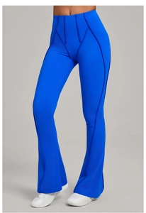 Detail of high waisted electric blue yoga flare pants with decorative vertical stitching