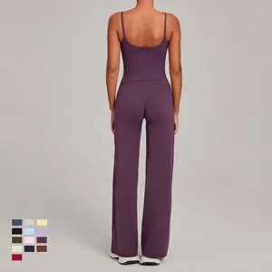 Women's back view of dark purple yoga set with thin strap top and high waist wide leg pants