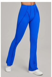 Close-up of high-waist yoga flare pants in royal blue with geometric seam detailing