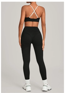 Detail view of high-waisted black yoga pants with push-up design for fitness training