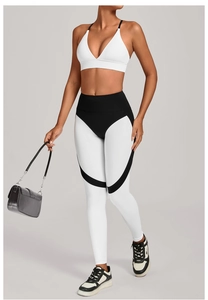 Detail of high-waist yoga set featuring white V-neck sports bra and color-block leggings