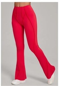 Detail of red high-waisted flare leggings with vertical seams and elastic brushed fabric
