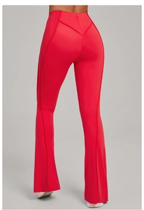 Detail view of red flared yoga pants with high waist and V-shaped stitching for bum lift