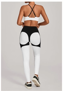 Detail view of white criss-cross sports bra and high-waisted colorblock yoga leggings