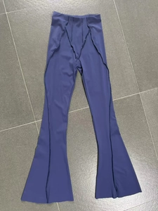 Detail of high waisted navy flared yoga pants with elegant vertical front seams