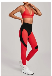 Detail view of red V-neck sports bra and color-block leggings fitness two-piece set