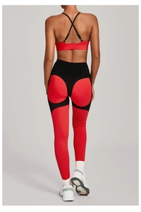 Back view of high-waisted red and black patchwork yoga set showing cross-back sports bra