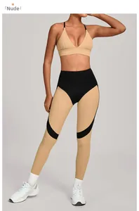 Detail view of high-waist color-block yoga leggings with nude and black curved stitching