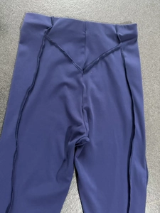 Detail of high waist yoga flare pants featuring a V-shaped back seam and supportive fabric