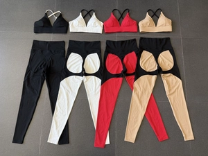 Flat lay of high-waist yoga sets in four colorways showing sports bra and leggings detail