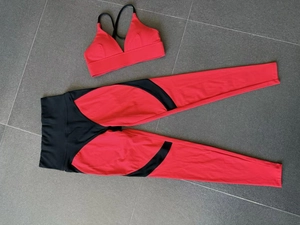 Detailed flat lay of red and black color-block yoga set with high waist compression leggings