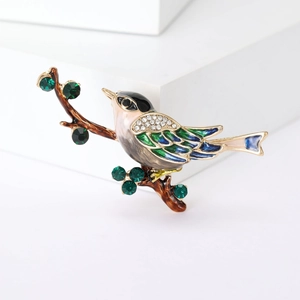 Élégante broche oiseau sur branche avec détails en émail coloré et strass scintillants