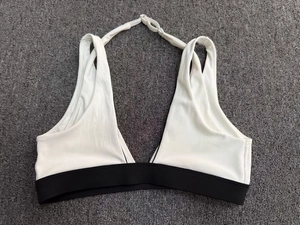 Détail des coutures contrastées et des bretelles réglables du soutien-gorge de sport col en V