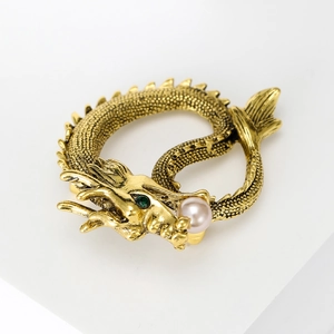 Vintage golden dragon brooch with green gemstone eye and white pearl detail for suits
