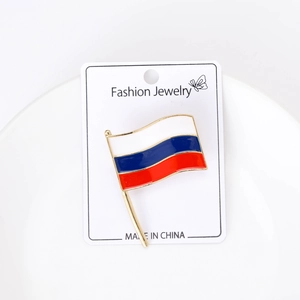 Detail of creative Russian flag brooch with gold plating on a fashion jewelry display card