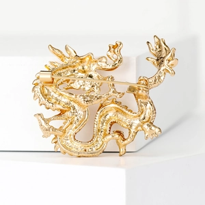 Elegant gold enamel Chinese dragon brooch with detailed texture and back pin closure
