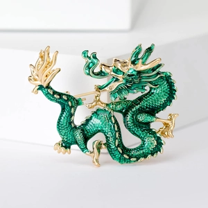 Detail of green enamel dragon brooch showing intricate scales and gold plating