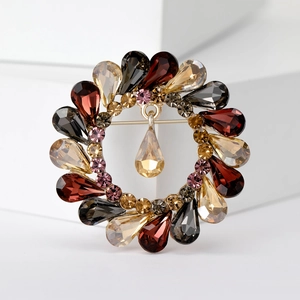 Macro detail of a vintage crystal wreath brooch with multi-colored teardrop rhinestones