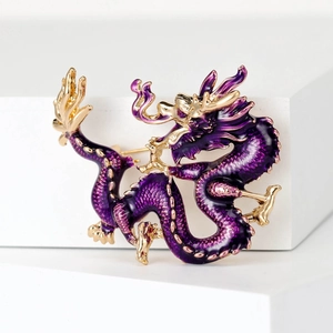 Macro shot of purple enamel Chinese dragon brooch with gold-tone metal detailing