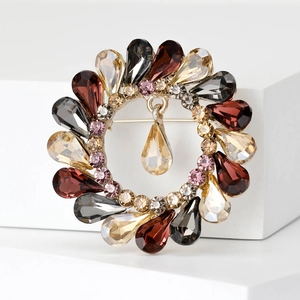 Detailed macro view of vintage round wreath brooch with multi-color rhinestones