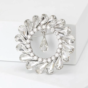 Exquisite silver-tone crystal wreath brooch with radiant teardrop pendant details