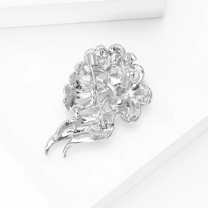 Silver flower brooch back view showing secure metal pin clasp and hollow pattern
