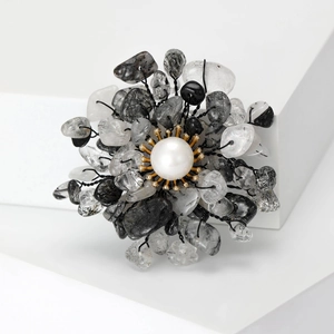Detail of flower brooch with natural black rutilated quartz and central pearl