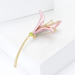Exquisite pink enamel lily flower brooch with gold plating on minimalist white display
