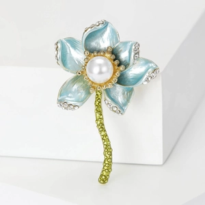 Detailed close-up of a blue enamel lotus brooch with a round pearl and crystals