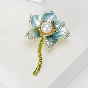 Detailed close-up of a blue enamel lotus brooch with white pearl and inlaid rhinestones