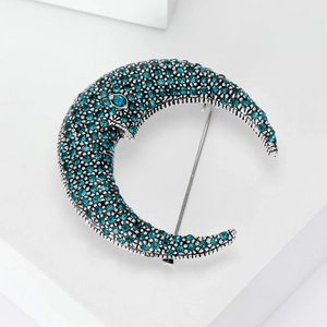 Vintage crescent moon brooch in antique silver finish with pavé set blue rhinestones