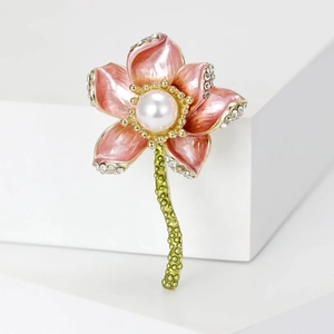 Detail of pink enamel lotus brooch with white pearl center and sparkling rhinestones