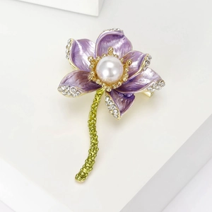Macro shot of purple lotus brooch featuring enamel petals, white pearl and sparkling crystals