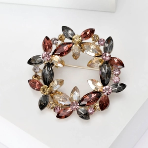 Detail of floral crystal brooch with multicolor rhinestones on a gold alloy base