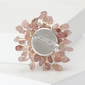 Macro detail of handmade flower brooch with crystal stones and silver pin fastener