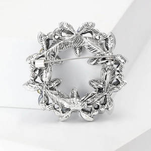Detail view of the silver vintage crystal brooch back showing the metal pin fastener
