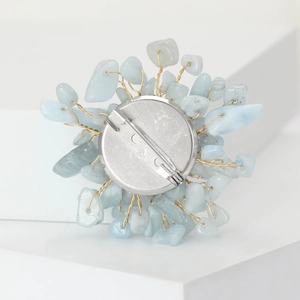 Macro view of the floral brooch back showing fine wire craft and secure silver pin clasp