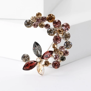 Elegante spilla a forma di luna e fiori con strass multicolori su base dorata