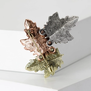 Detailed back view of maple leaf brooch showing secure metal pin clasp and leaf texture