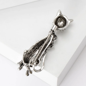 Retro cat brooch in silver finish with realistic fur texture on white geometric background