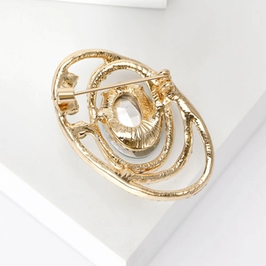 Vintage gold plated oval brooch with crystal stone showing secure back pin clasp details
